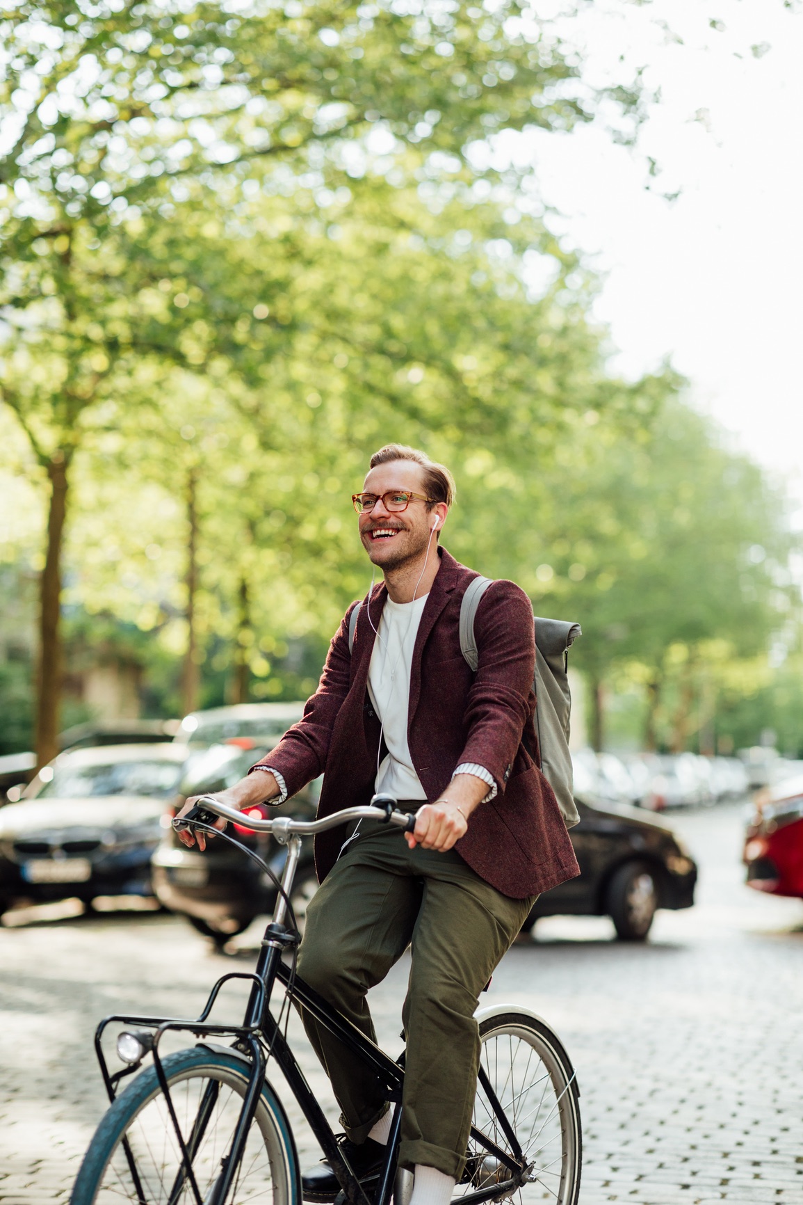A man riding a bike through the city streets.
