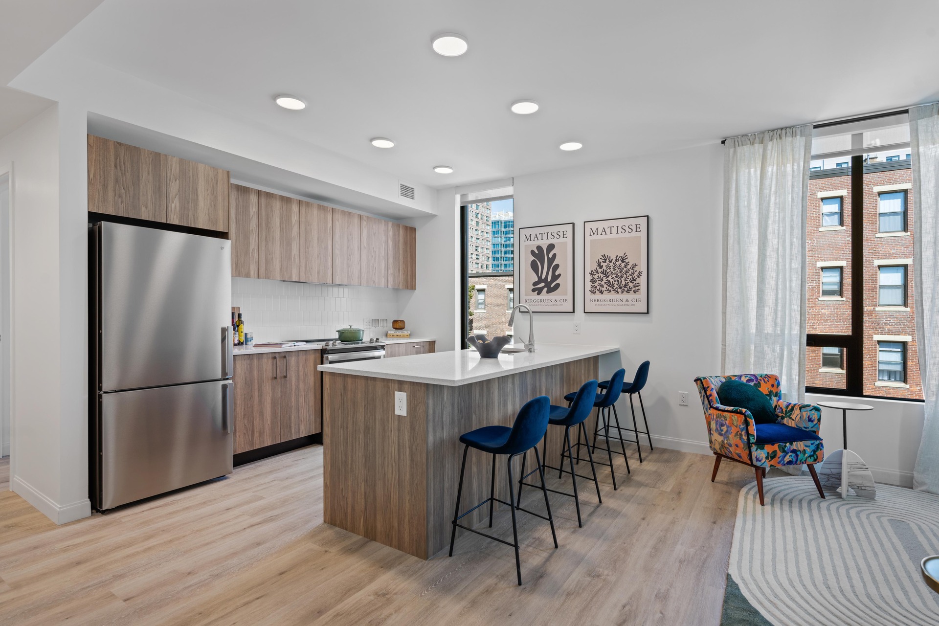 Modern kitchen with bright lighting and sleek appliances.