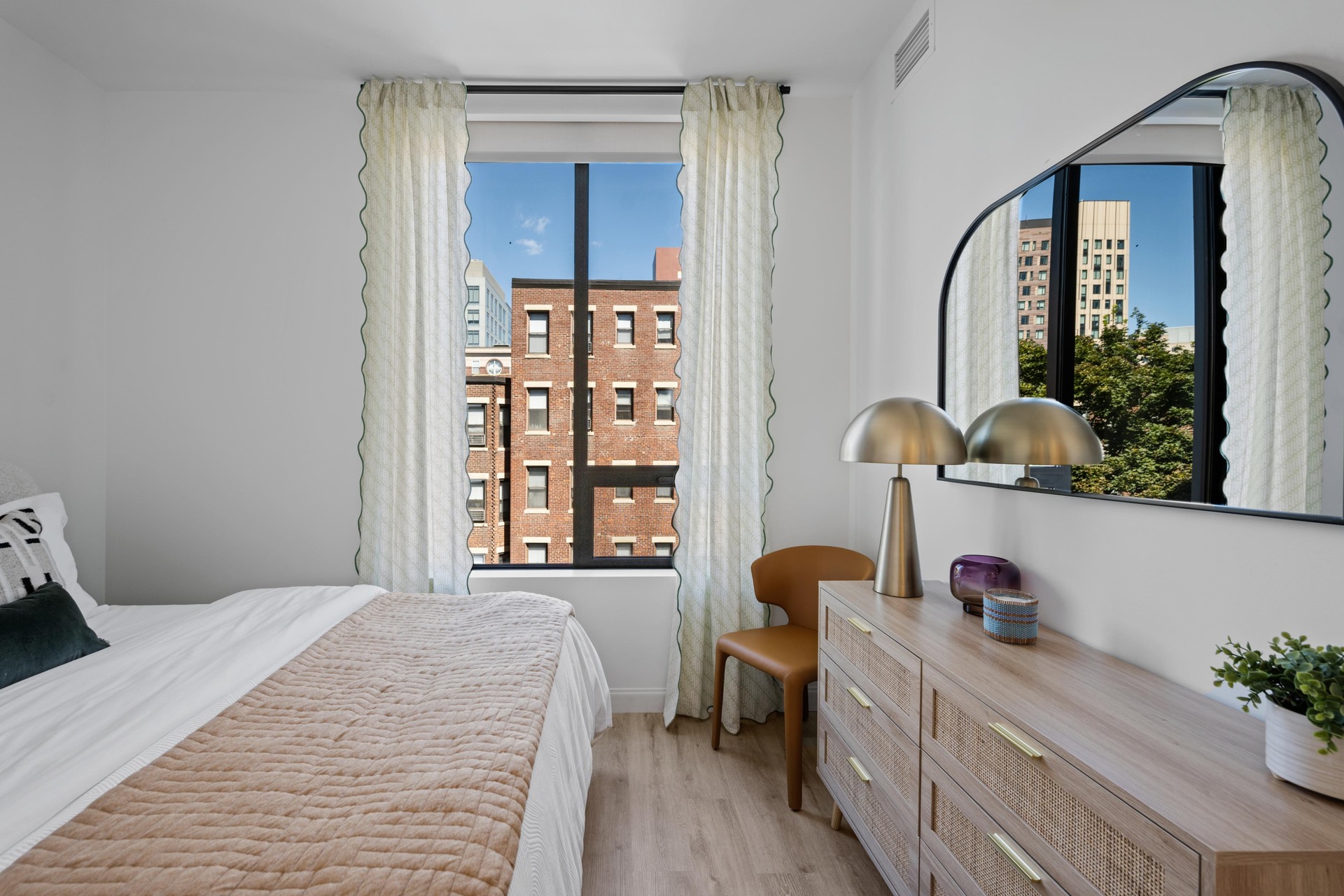 Bright primary bedroom with natural light.