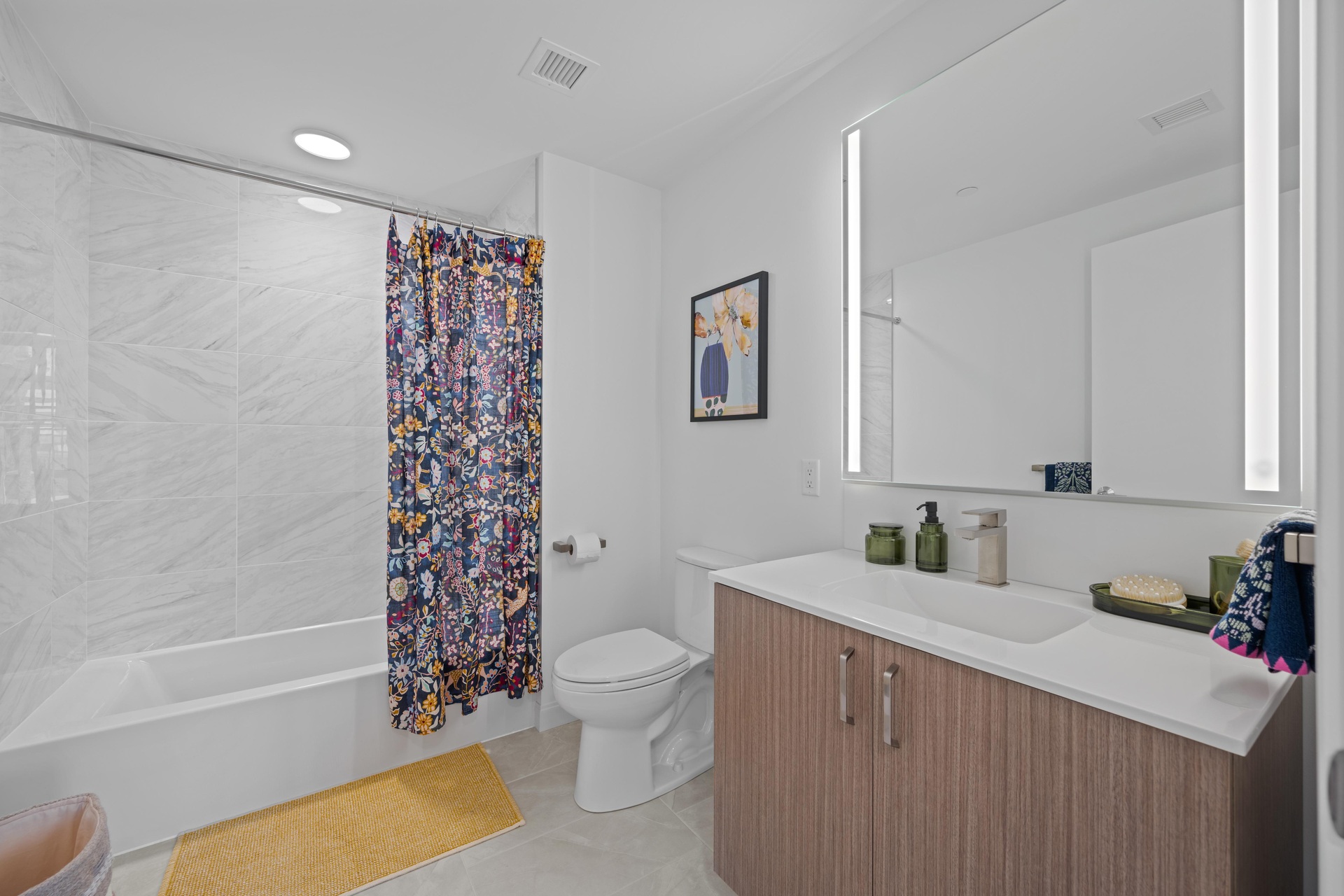 Ensuite bathroom featuring a chic tub.