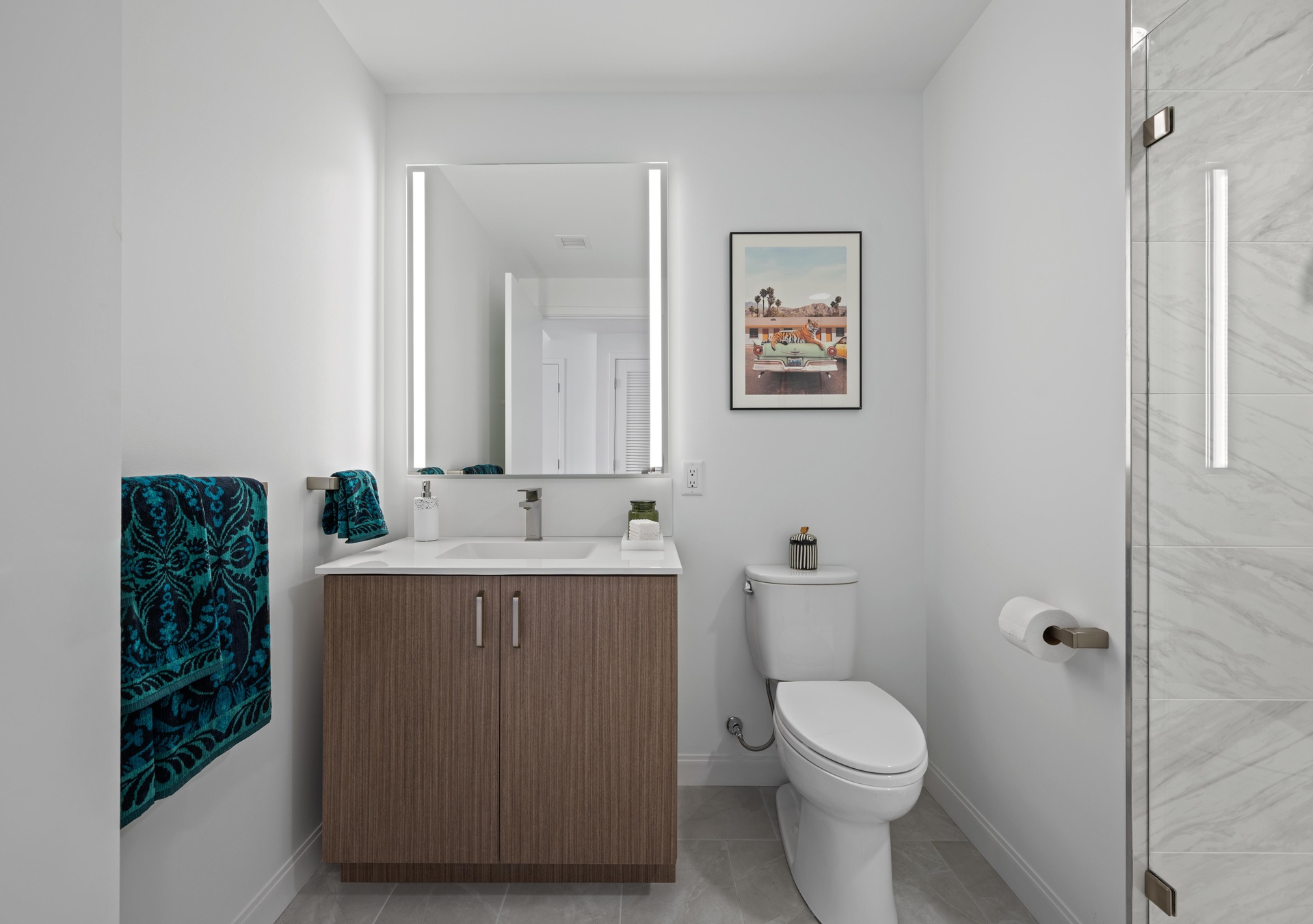 Studio bathroom vanity with a lit mirror.